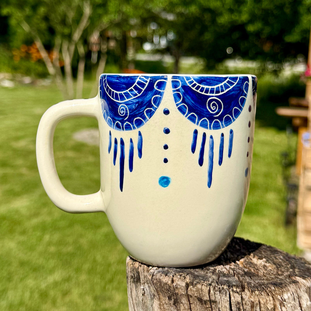 Handmade ceramic mug with artistic design