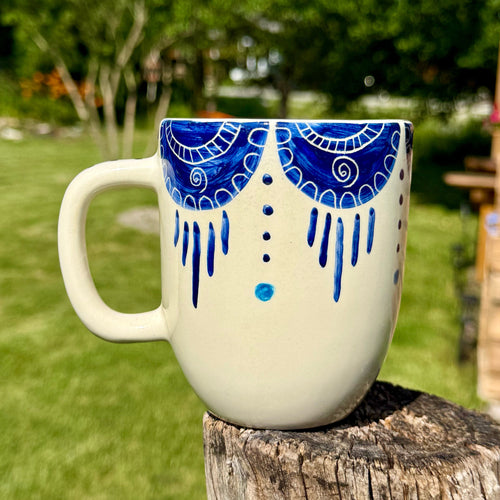 Handmade ceramic mug with artistic design