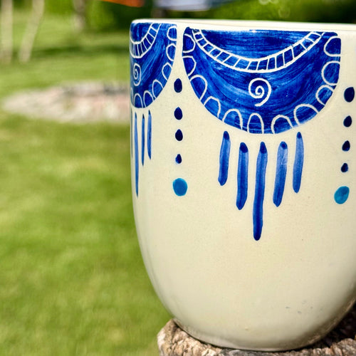 Handmade ceramic mug with artistic design